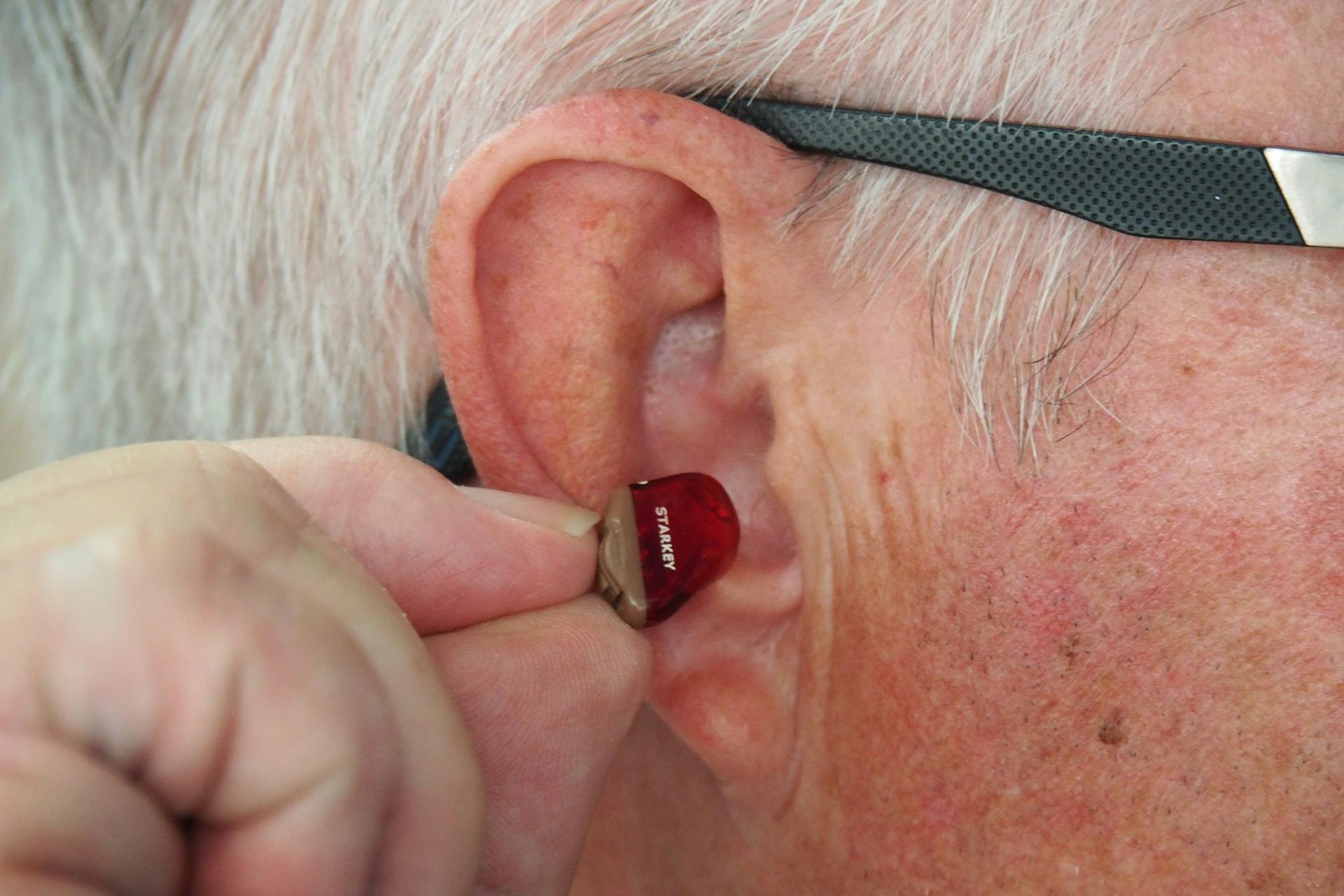 What Does Medicare Not Cover - hearing aid close up of ear.jpg